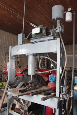 La presse qui sert à construire des patentes à la Ferme Marygold a été fabriquée de toutes pièces par Gérard Dutil. Le patenteux s’est, entre autres, servi d’une vieille pompe hydraulique utilisée pour un écureur, et d’une partie d’un ancien système électrique d’étable. © Étienne Dupuis