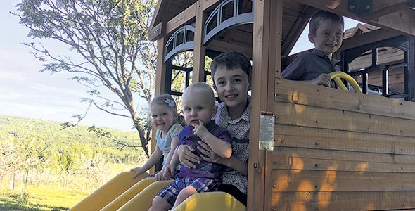 Les quatre enfants de la famille accompagnent leurs parents au verger. L’un d’entre eux, Zackary, est même le gardien du module de jeu.